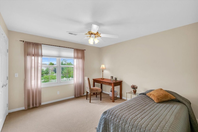 carpeted bedroom with visible vents, a ceiling fan, and baseboards