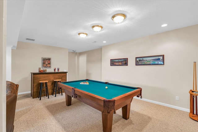 recreation room featuring visible vents, baseboards, carpet, and a dry bar