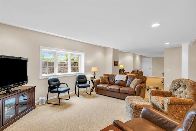 living room featuring carpet flooring, recessed lighting, baseboards, and decorative columns