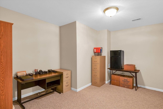 office space with visible vents, baseboards, and carpet flooring