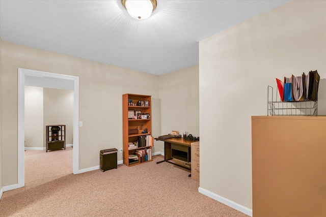 interior space featuring baseboards and light carpet