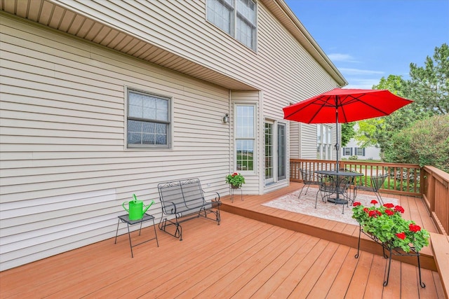 wooden deck featuring outdoor dining area