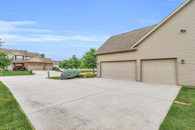 garage with concrete driveway