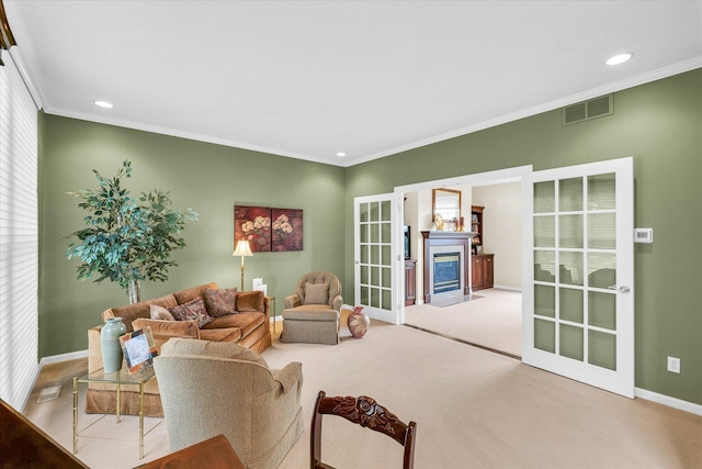 carpeted living area with visible vents, a fireplace with flush hearth, recessed lighting, crown molding, and baseboards