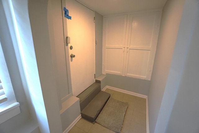 hallway featuring light tile patterned flooring