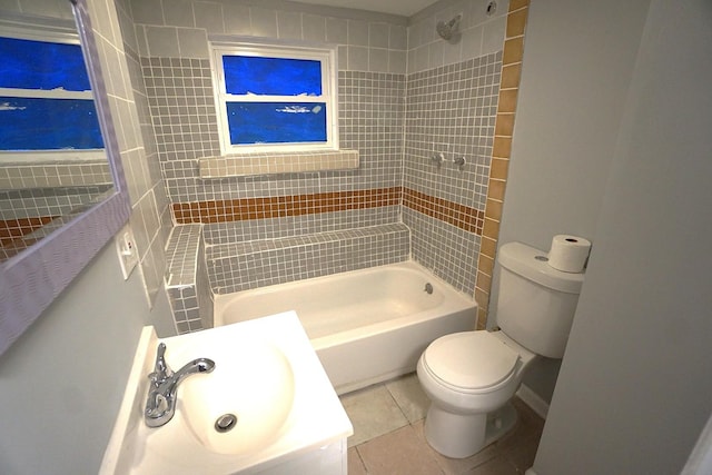 full bathroom featuring tile patterned flooring, tiled shower / bath, sink, and toilet