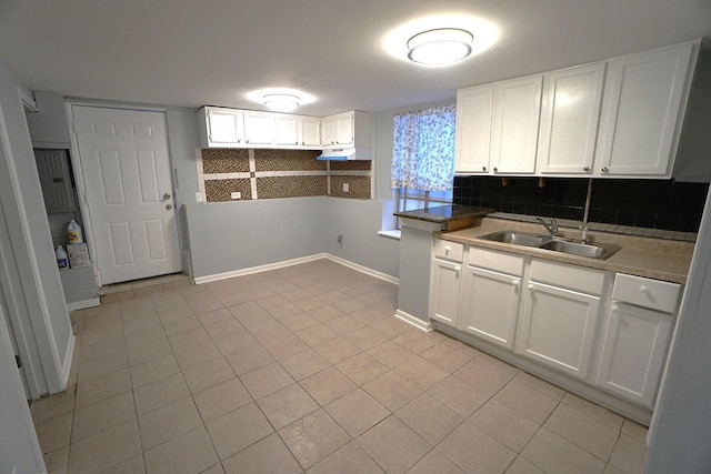 kitchen with light tile patterned flooring, sink, decorative backsplash, and white cabinets