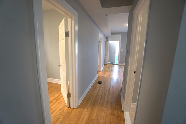 hall with light hardwood / wood-style flooring