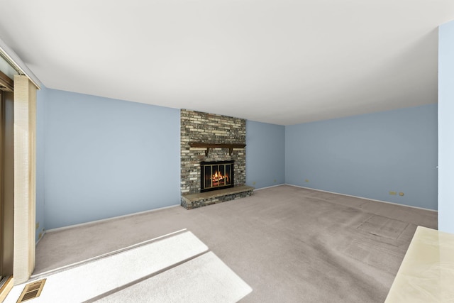 unfurnished living room featuring a brick fireplace, visible vents, and carpet flooring