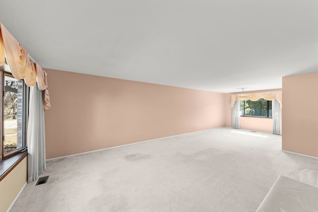 empty room featuring light carpet and visible vents