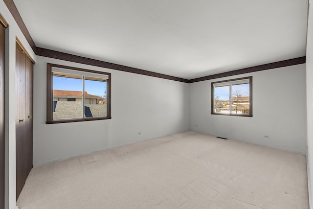 carpeted empty room featuring a healthy amount of sunlight