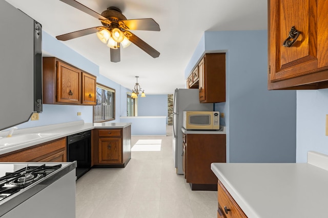 kitchen with brown cabinetry, white appliances, decorative light fixtures, and a peninsula