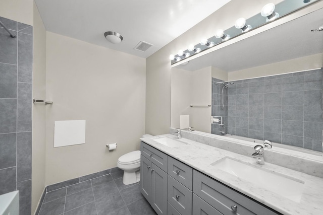 bathroom with tile patterned flooring, vanity, and toilet