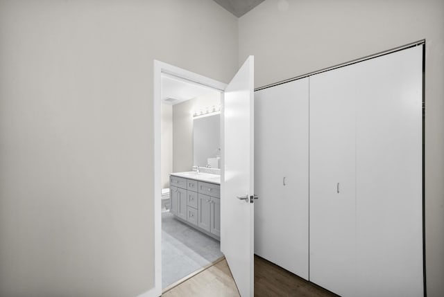 bathroom featuring vanity, toilet, and hardwood / wood-style floors