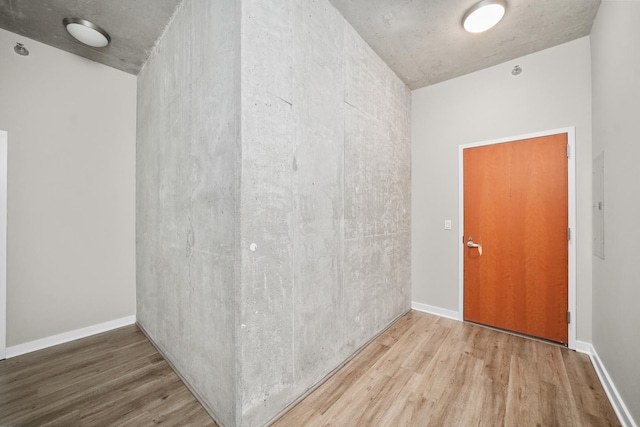 spare room featuring hardwood / wood-style flooring and electric panel