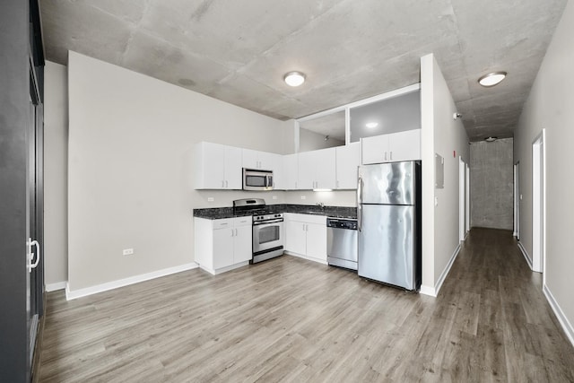 kitchen featuring white cabinetry, light hardwood / wood-style floors, and appliances with stainless steel finishes