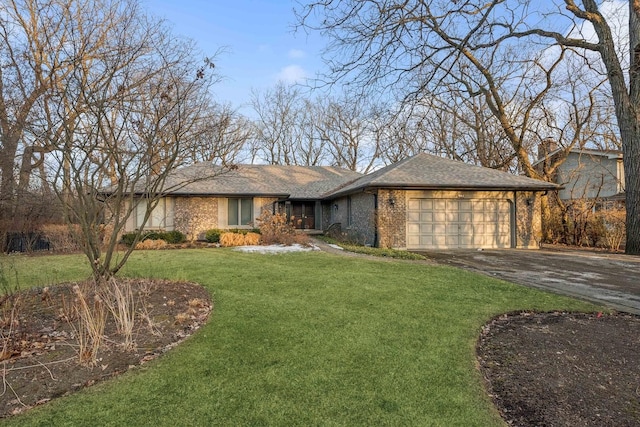 ranch-style house featuring a garage and a front yard