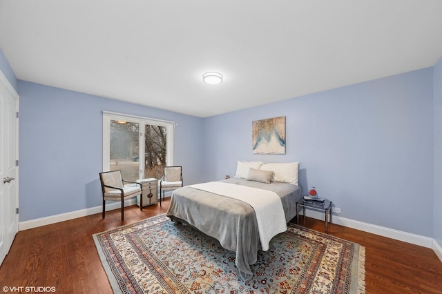 bedroom with dark wood-type flooring