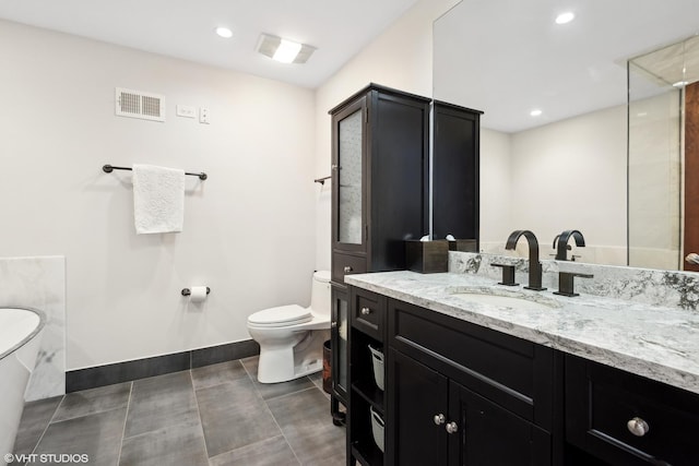 bathroom featuring tile patterned floors, vanity, and toilet