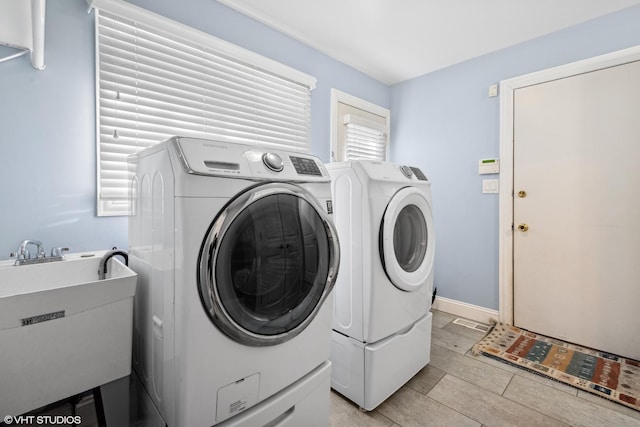 washroom with washer and clothes dryer and sink