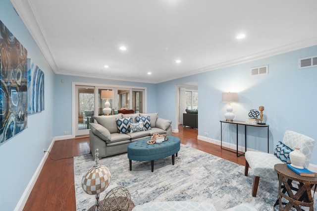 living room featuring crown molding and hardwood / wood-style floors