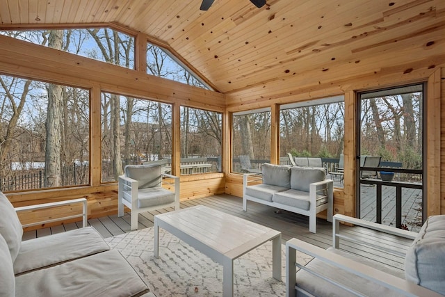 sunroom / solarium featuring ceiling fan, a healthy amount of sunlight, vaulted ceiling, and wooden ceiling