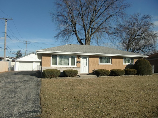 ranch-style home with an outbuilding, a garage, and a front yard