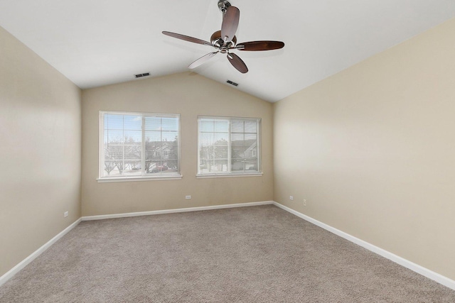 spare room featuring lofted ceiling, carpet, and ceiling fan