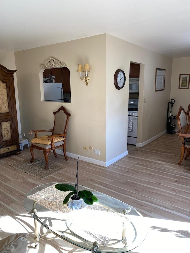 interior space with light wood-type flooring and baseboards