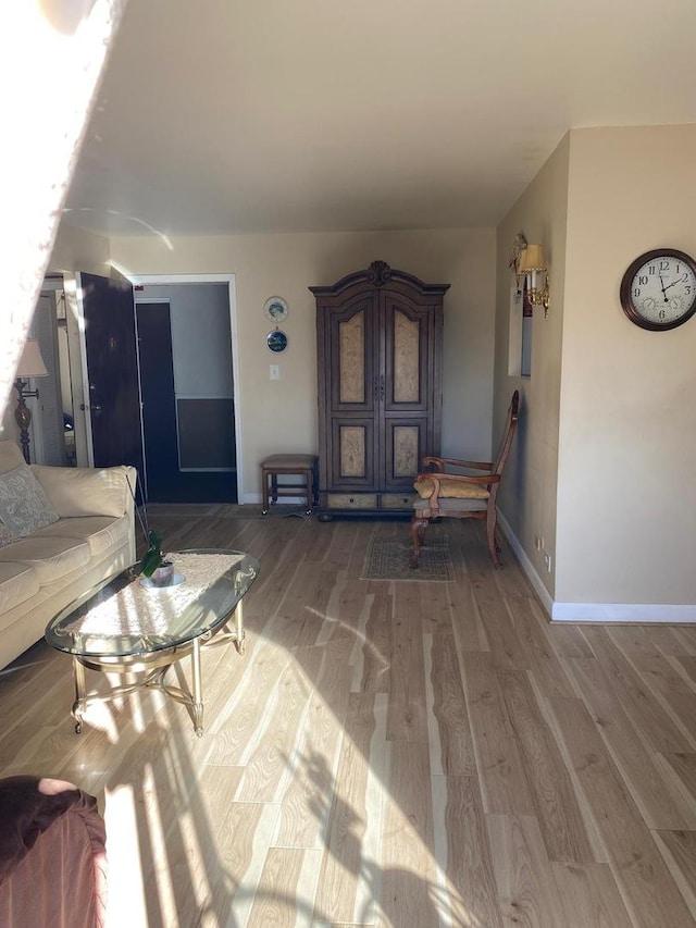 interior space featuring wood finished floors and baseboards