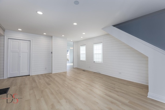 additional living space with light hardwood / wood-style flooring