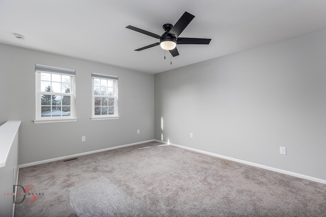 carpeted spare room with ceiling fan