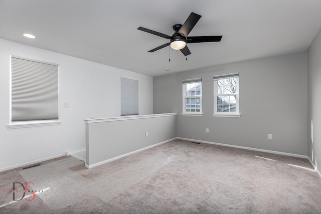 carpeted spare room featuring ceiling fan