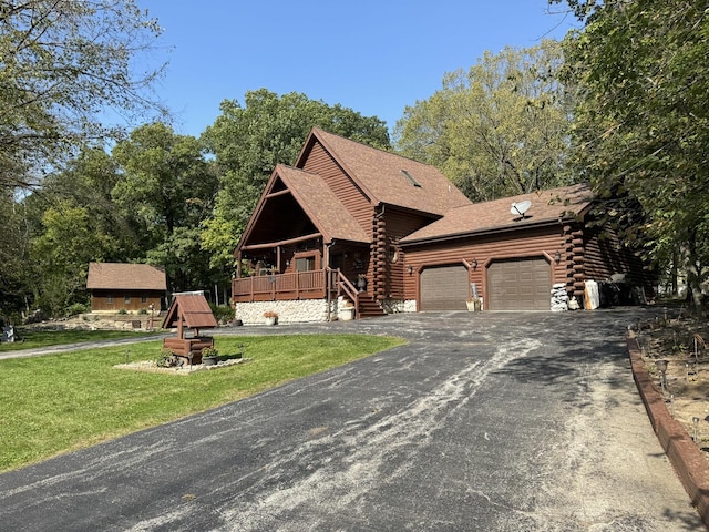 cabin with a garage and a front yard