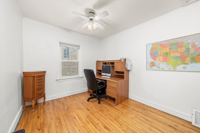 office area with ceiling fan, light wood-type flooring, visible vents, and baseboards