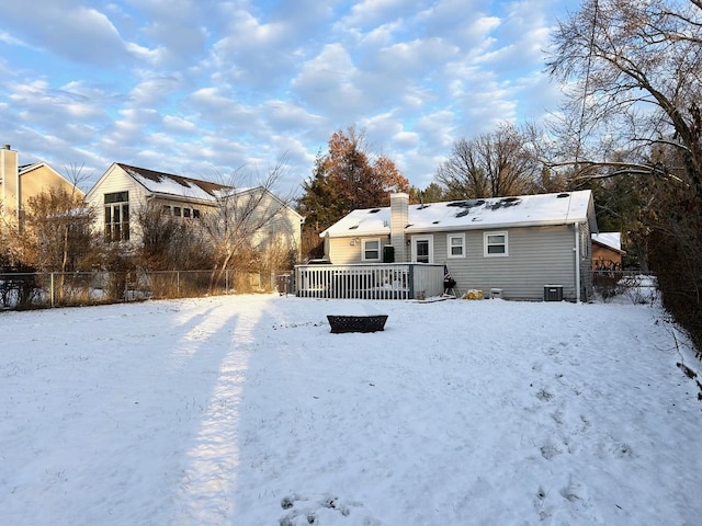 snow covered rear of property featuring a wooden deck