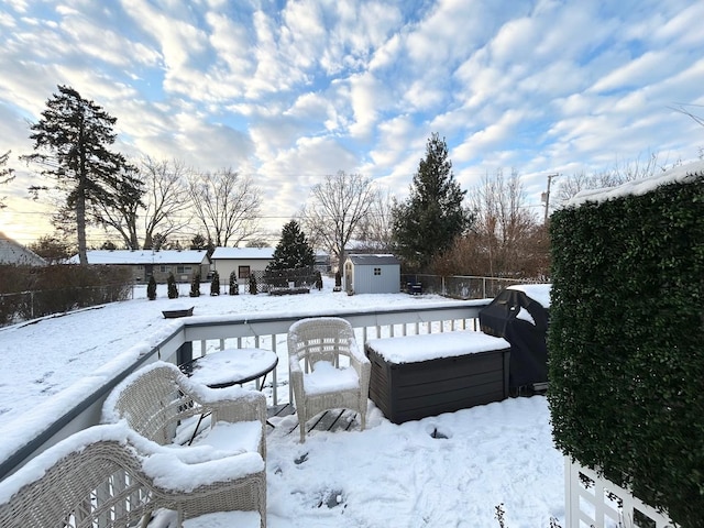 snowy yard with a shed