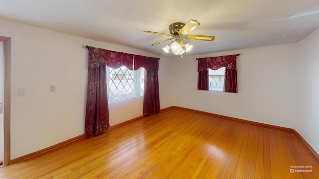 empty room with ceiling fan and wood-type flooring