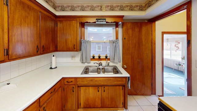 kitchen featuring sink, decorative backsplash, and light tile patterned floors