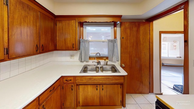 kitchen featuring sink, backsplash, and light tile patterned floors