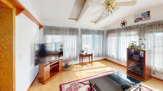 sunroom featuring vaulted ceiling and ceiling fan