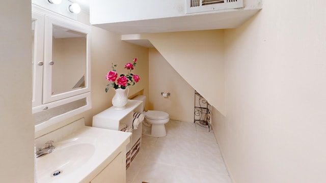 bathroom with tile patterned flooring, vanity, and toilet