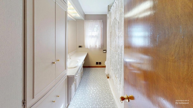 bathroom featuring tile patterned flooring and vanity