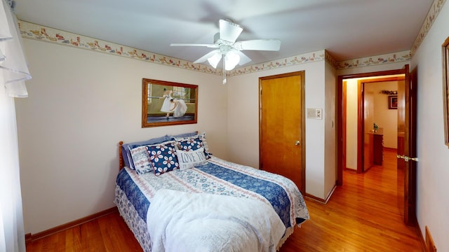 bedroom with hardwood / wood-style floors and ceiling fan