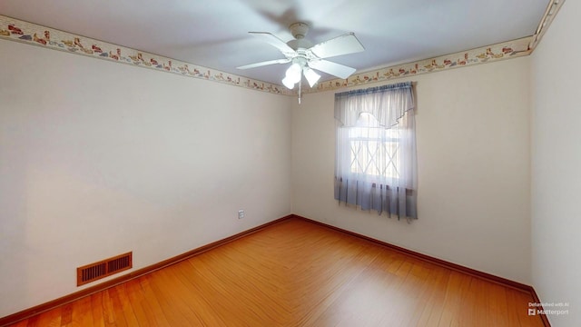 empty room with wood-type flooring and ceiling fan