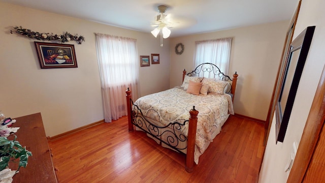 bedroom with ceiling fan and light hardwood / wood-style flooring