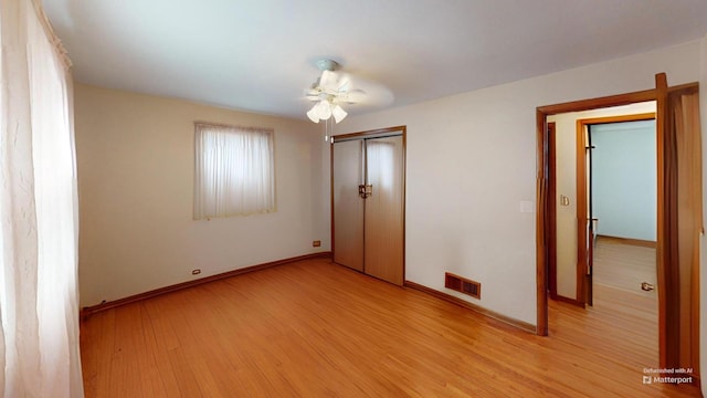 unfurnished bedroom with ceiling fan, a closet, and light hardwood / wood-style flooring