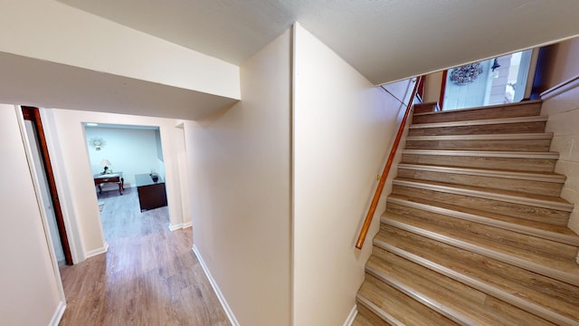 staircase featuring hardwood / wood-style flooring