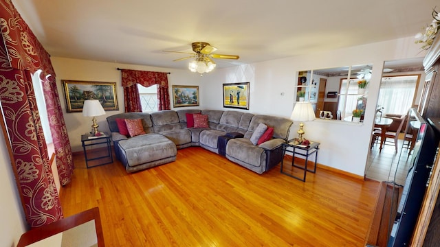 living room featuring wood-type flooring, a wealth of natural light, and ceiling fan