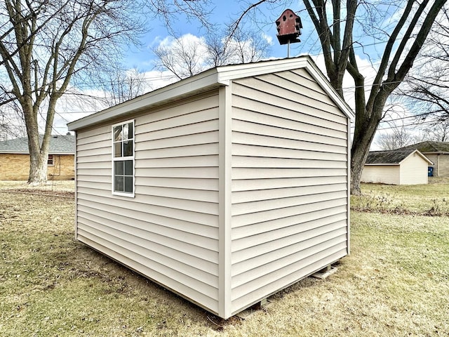 view of outbuilding with a lawn